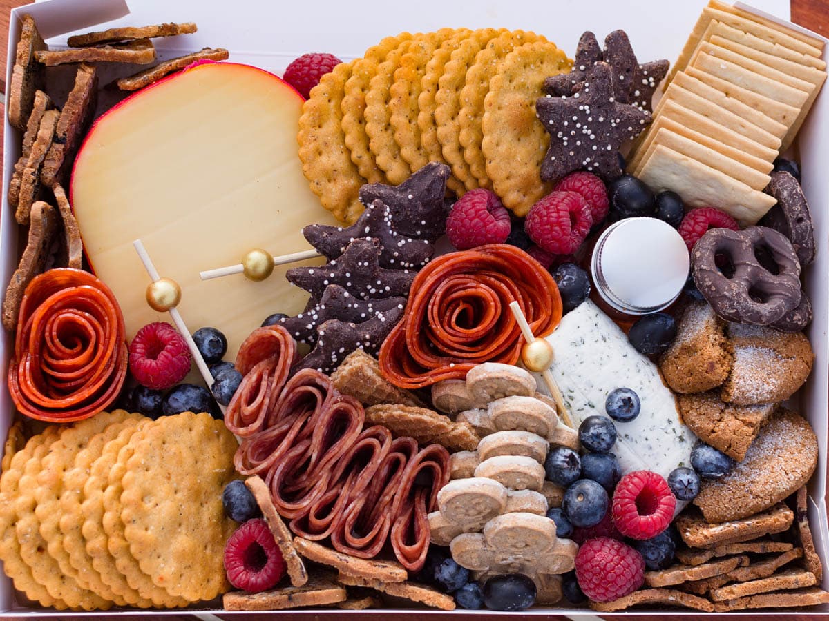 Vibrant charcuterie board near me featuring an elegant arrangement of fresh cheeses, cured meats, seasonal fruits, artisan crackers, and savory accompaniments, perfect for gatherings and events. Find the best charcuterie near you for any occasion.