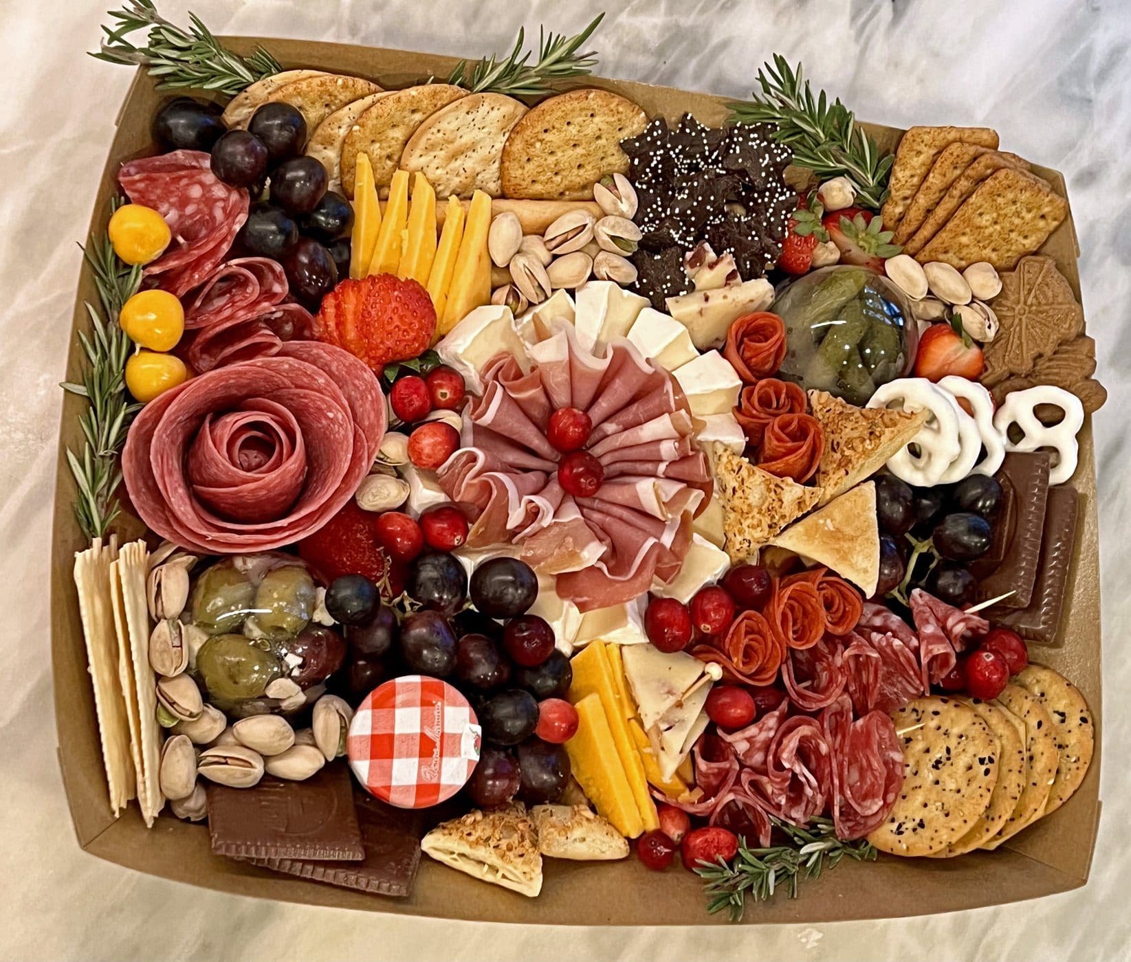 A beautifully crafted charcuterie board featuring an array of gourmet cheeses, cured meats, fresh fruits, artisan crackers, and delectable spreads—perfect for any gathering!
