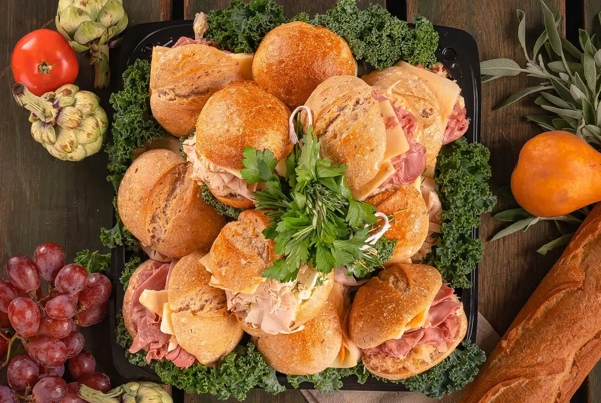 Mini sandwich platter with assorted turkey, roast beef, ham, caprese, and cucumber sandwiches