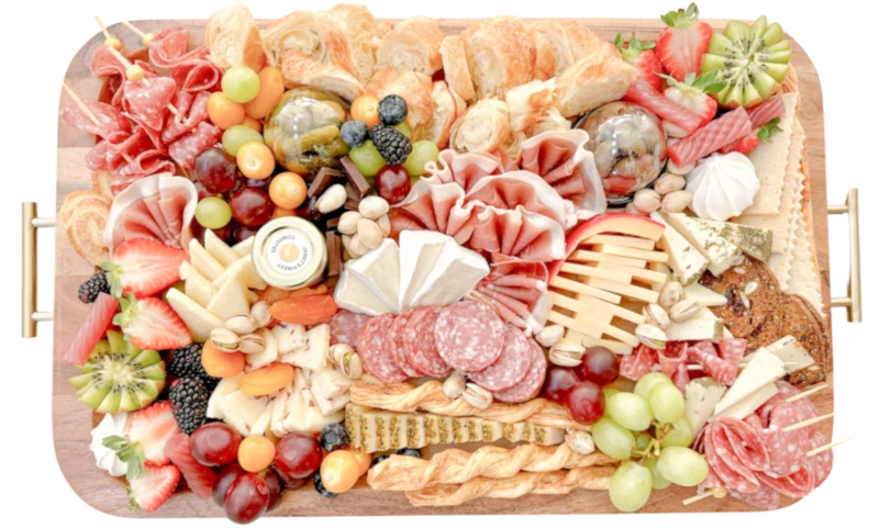 Infographic by Fork and Flare titled “Grazing Table Shopping List for 50 People,” featuring recommended quantities of artisan cheeses, cured meats, fruits, vegetables, crackers, crudités, dips, breads, and desserts, designed for Orange County catering events and charcuterie enthusiasts planning large gatherings.